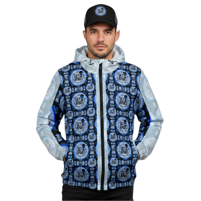 Man in a black baseball cap and a zip-up hoodie featuring a repetitive blue and black "Set Apart" alien emblem pattern.