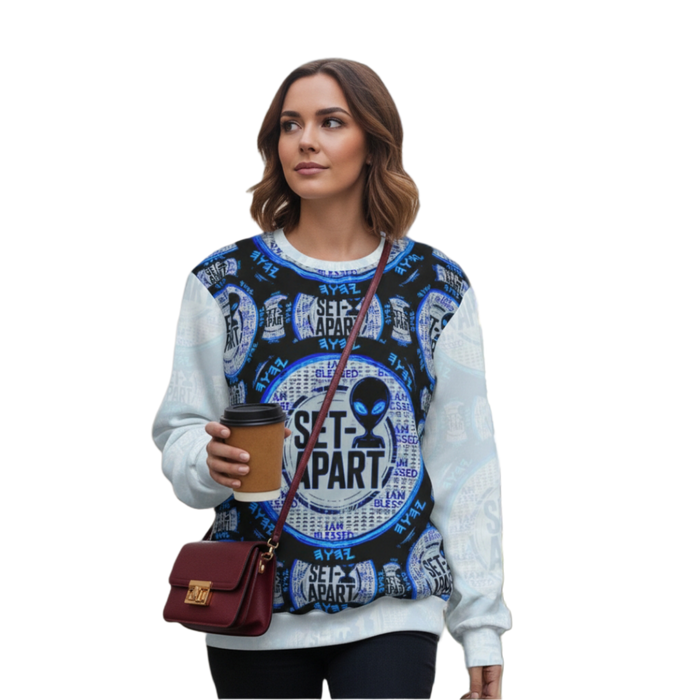 Woman in a sweatshirt with a bold blue and black "SET-APART" alien design, holding coffee.